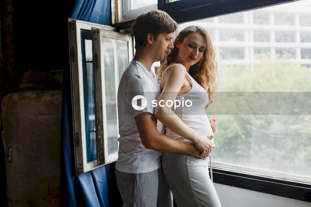 Man in white t-shirt hugging woman in white t-shirt