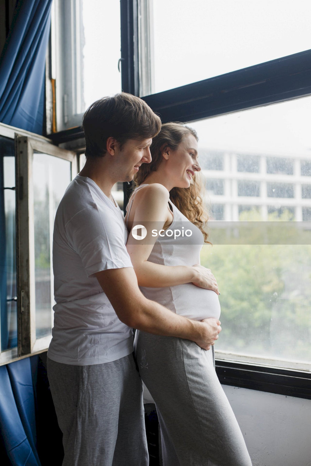Man in white t-shirt hugging woman in white t-shirt