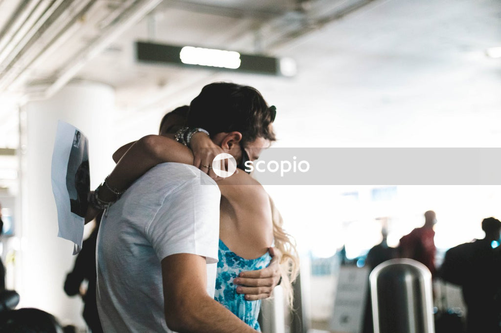 Man and woman hugging at the airport