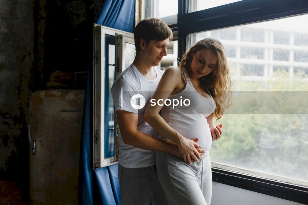 Man in white tank top hugging woman in white tank top