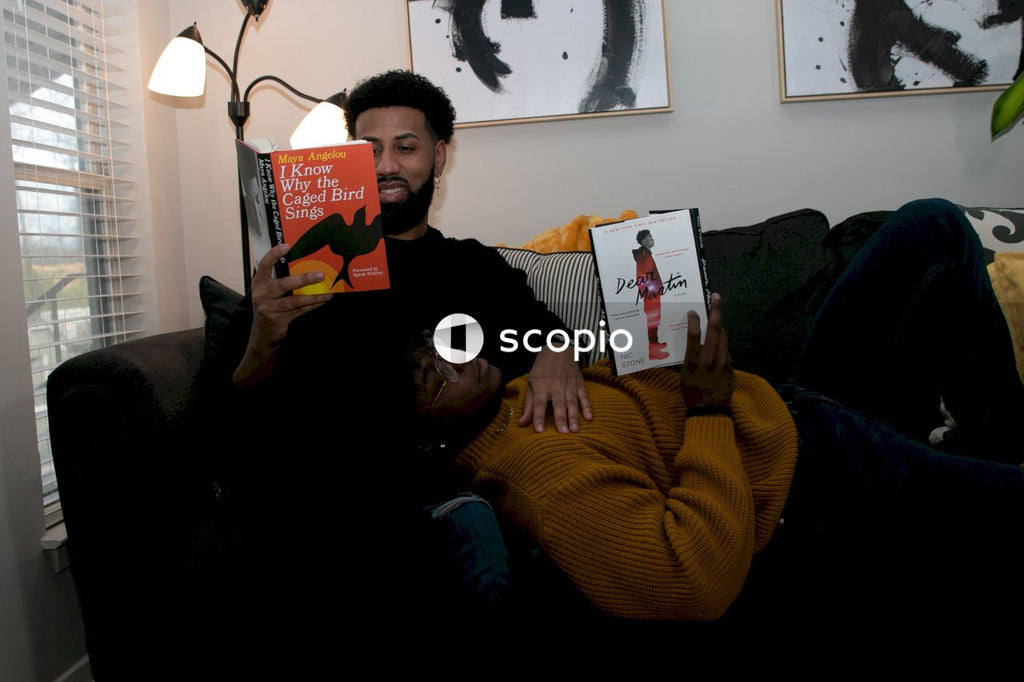 Couple lying on the couch reading books