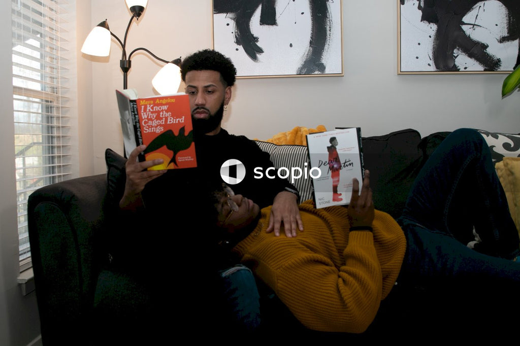 Couple lying on the couch reading books