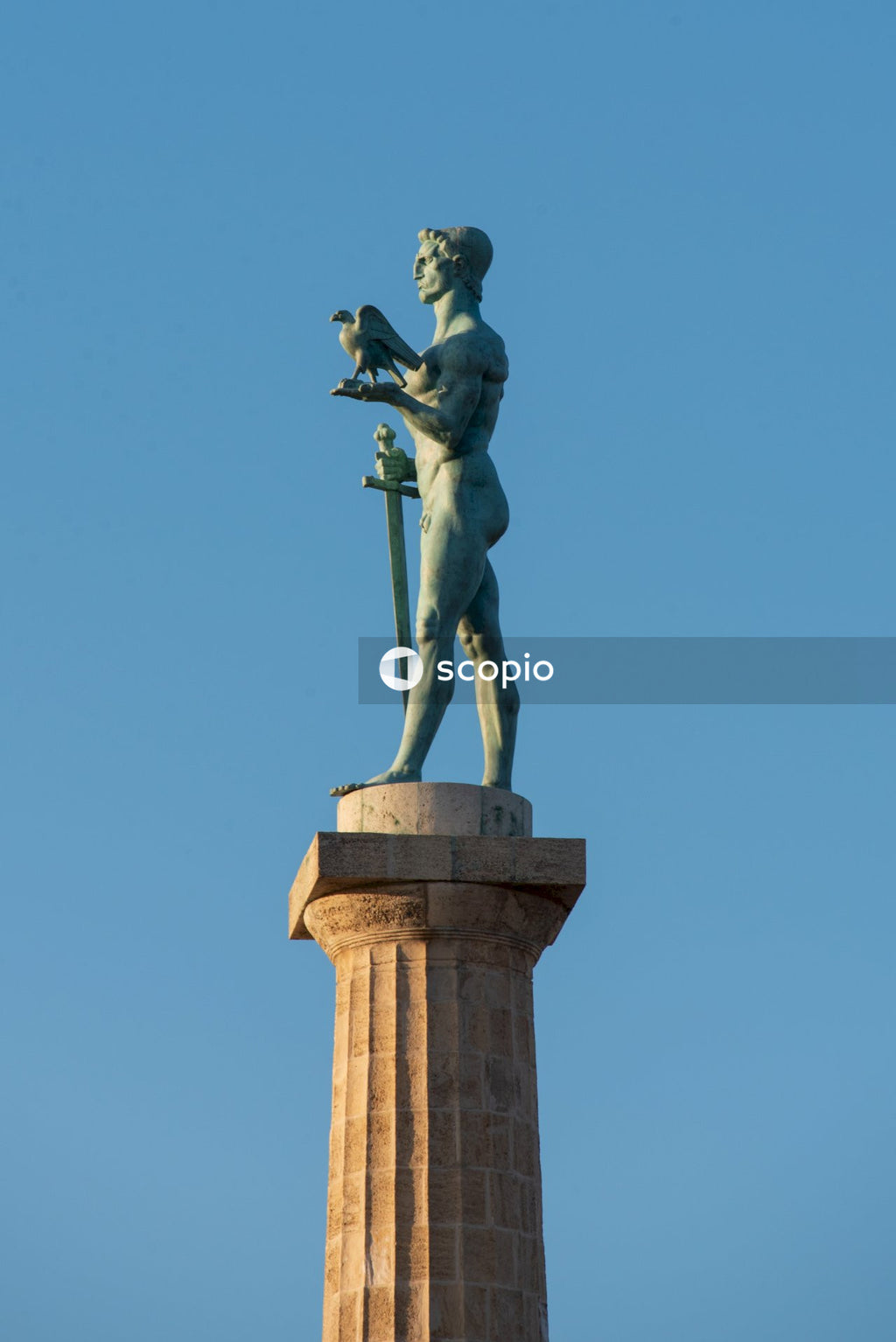 Man riding horse statue under blue sky