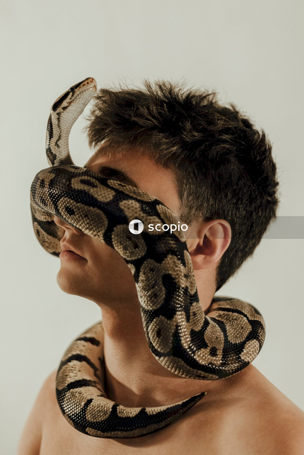 Man with snake on his neck and face