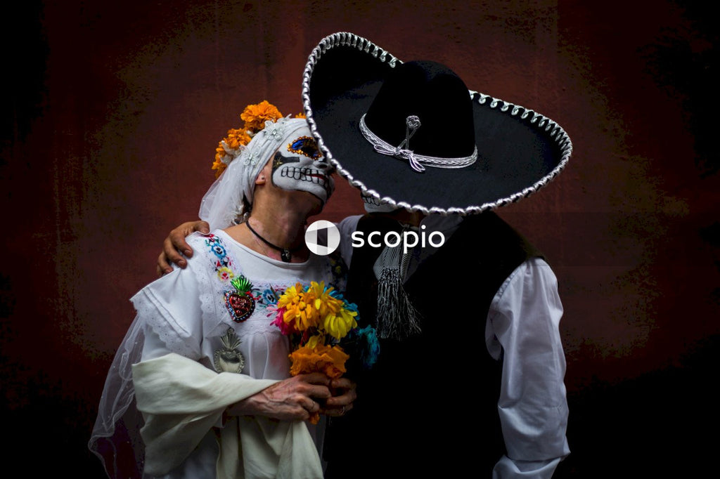 Mexican bride and groom with sugar skull face paint