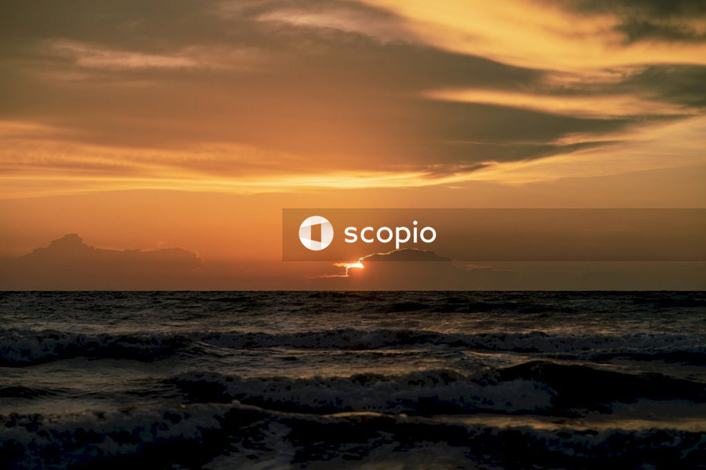 Ocean waves crashing on shore during sunset
