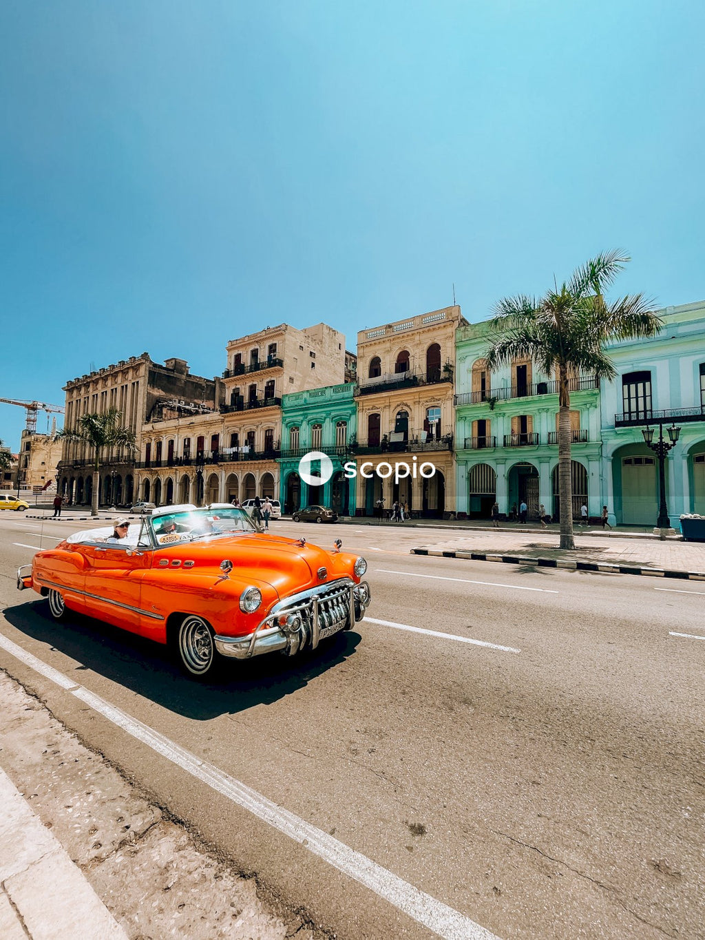 Orange car on road near buildings