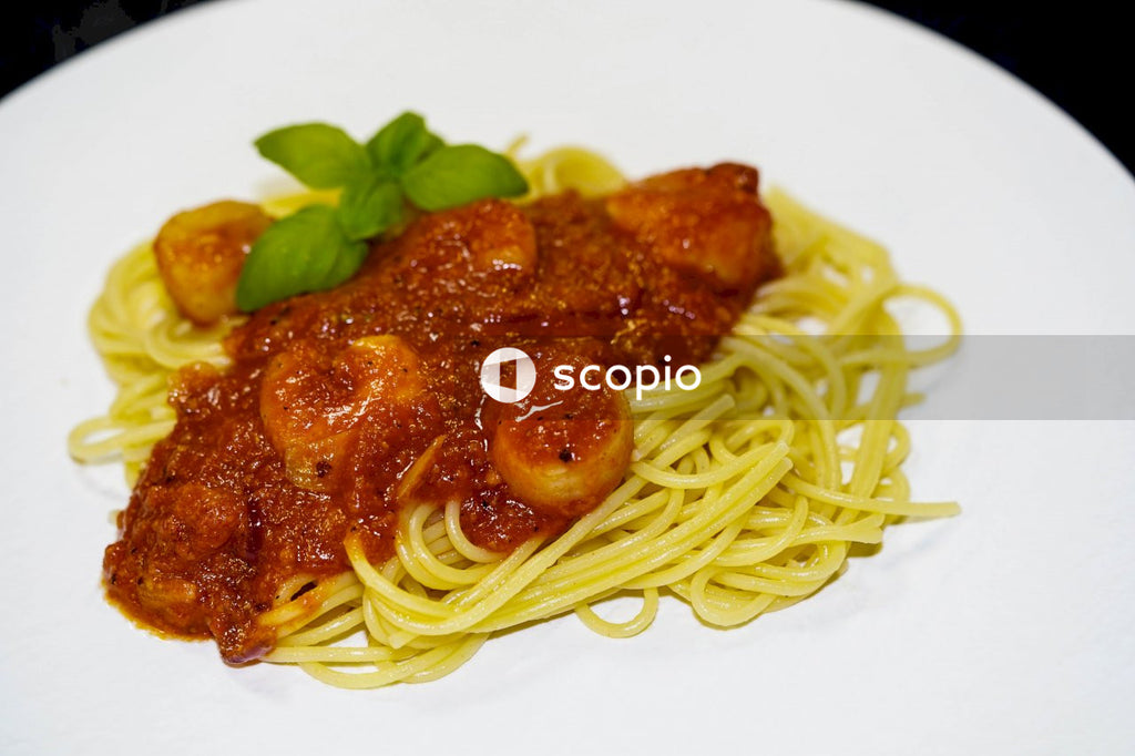 Pasta with meat on white ceramic plate