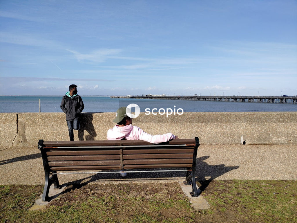 People sitting on brown wooden bench