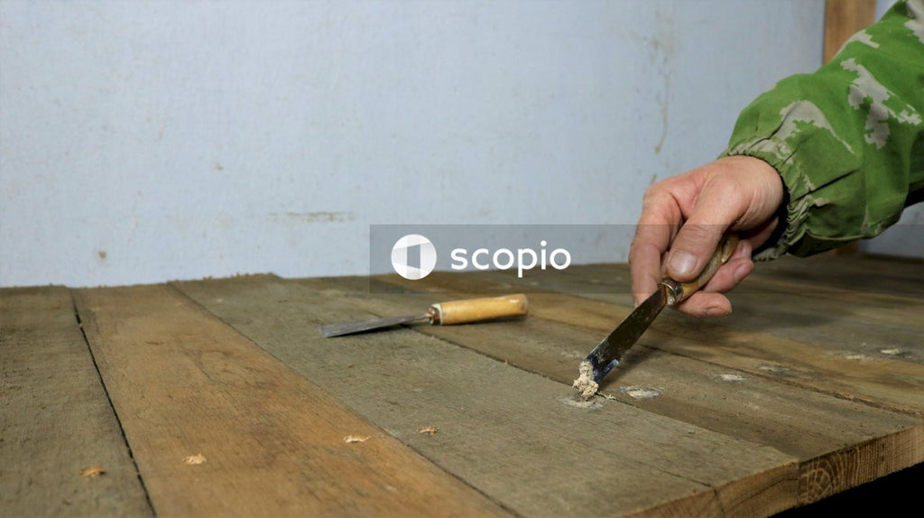 Person holding black and brown hand tool