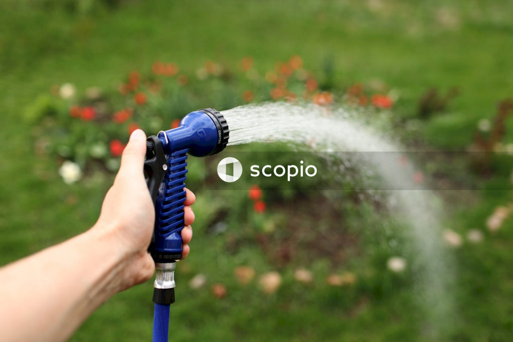 Person holding blue and white water hose