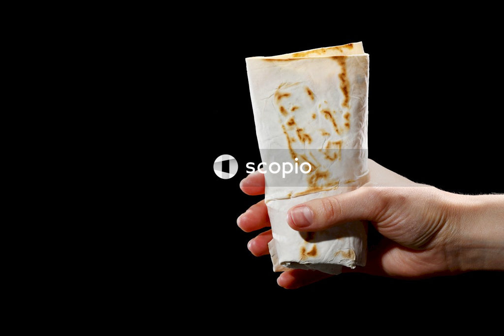 Person holding brown and white paper