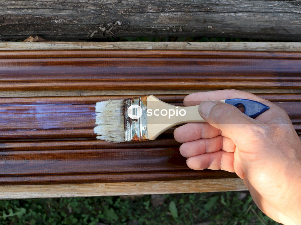 Person holding brown wooden brush