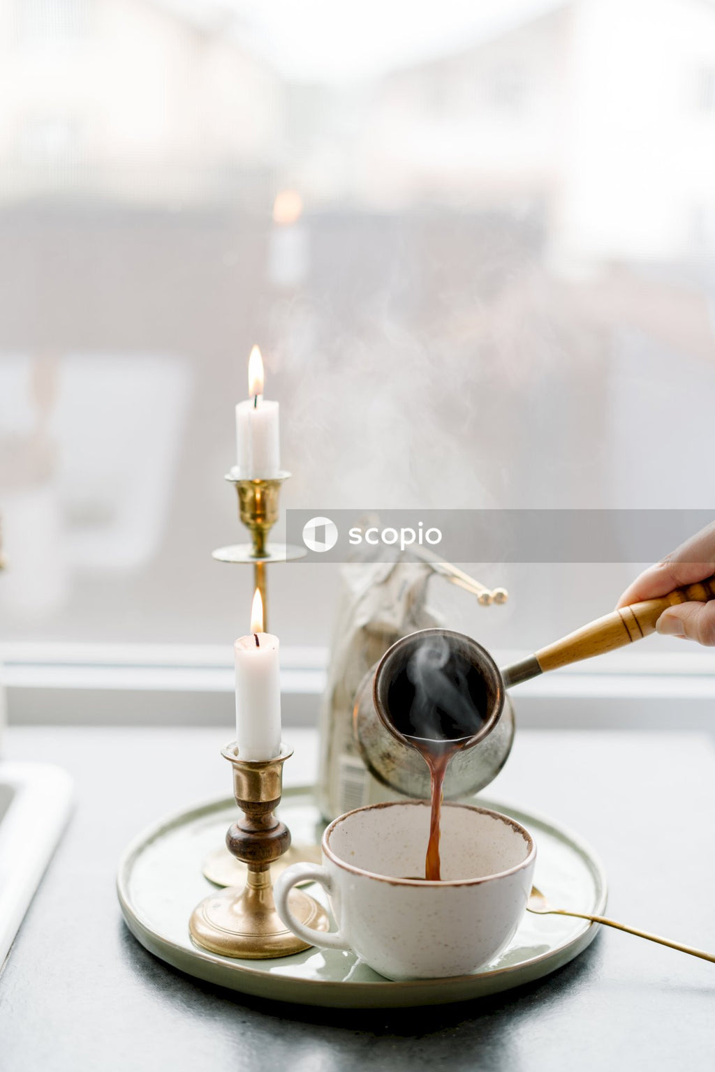Person holding gold candle holder