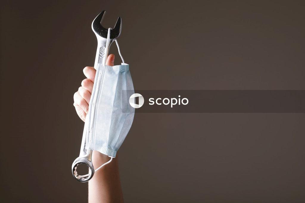Person holding gray and black hand tool