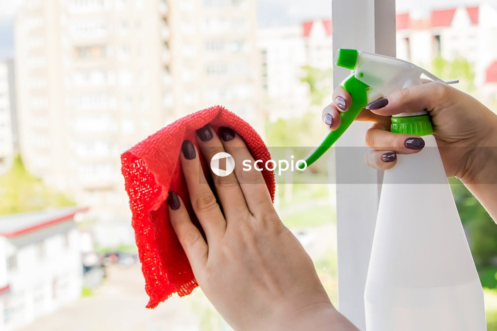 Person holding green and white toothbrush