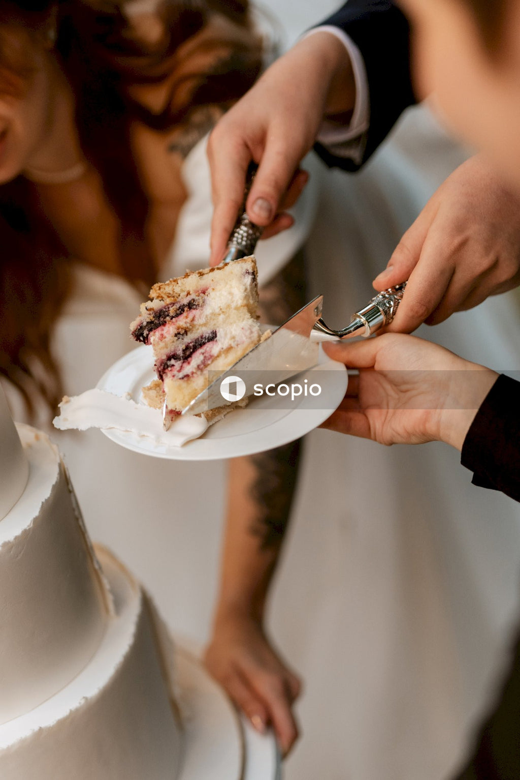 Person holding knife slicing cake