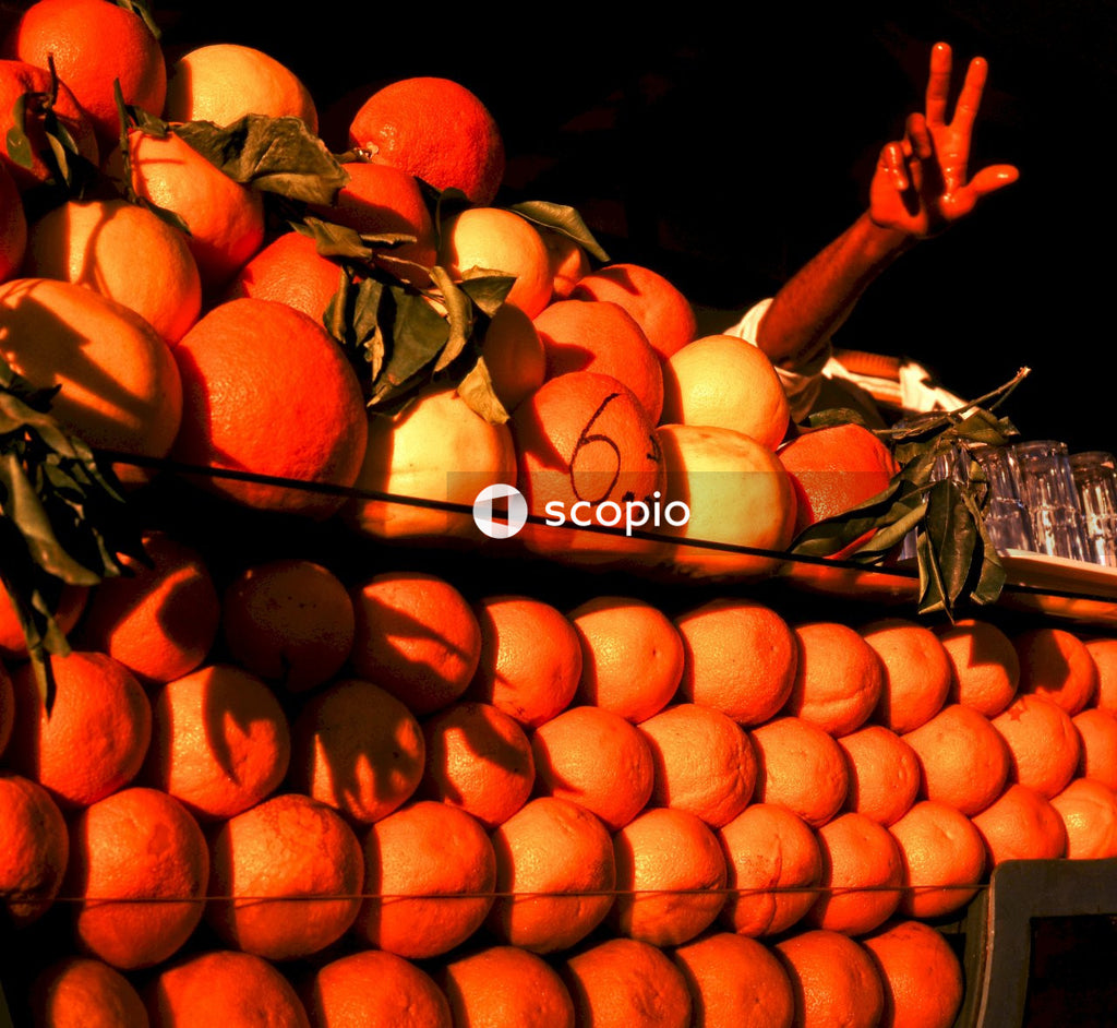 Person holding orange fruit lot