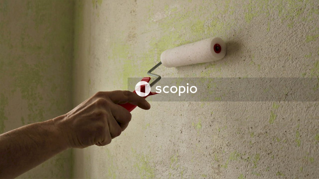 Person holding red and black plastic tool