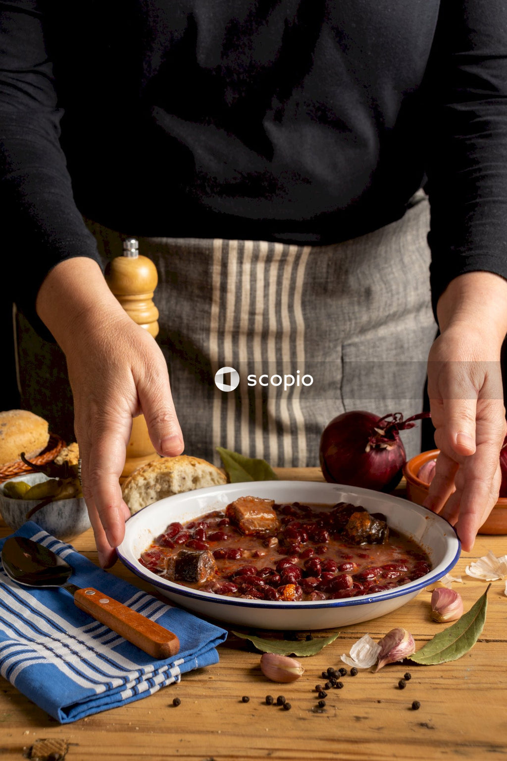 Person holding red fruit and white ceramic plate