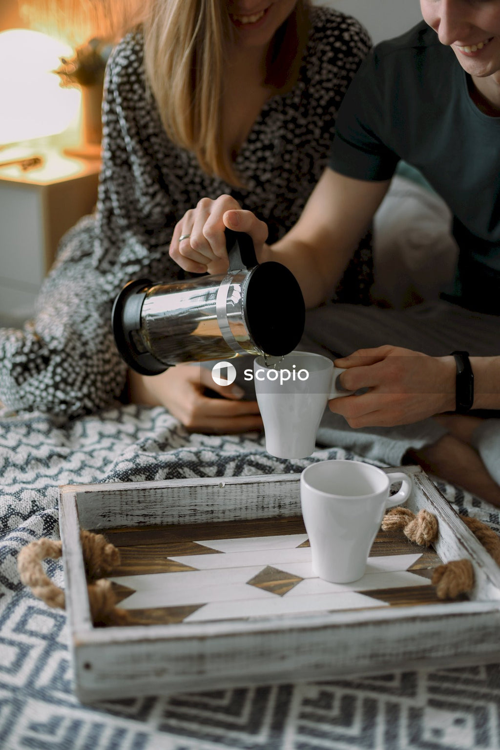Couple drinking tea on bed