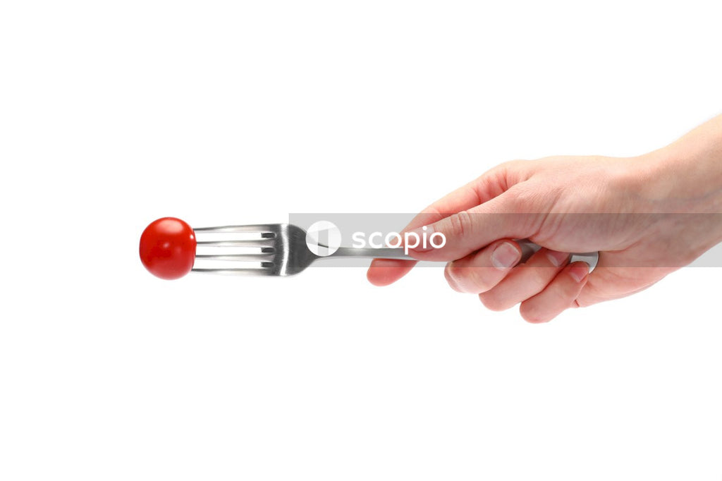 Person holding stainless steel fork