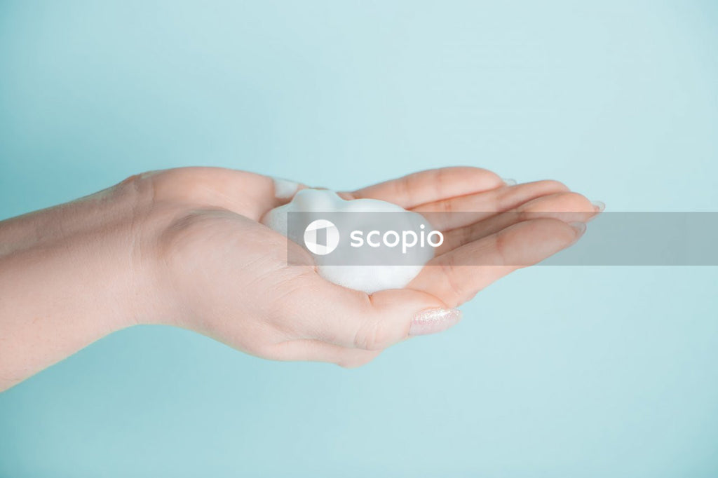 Person holding white egg in close up