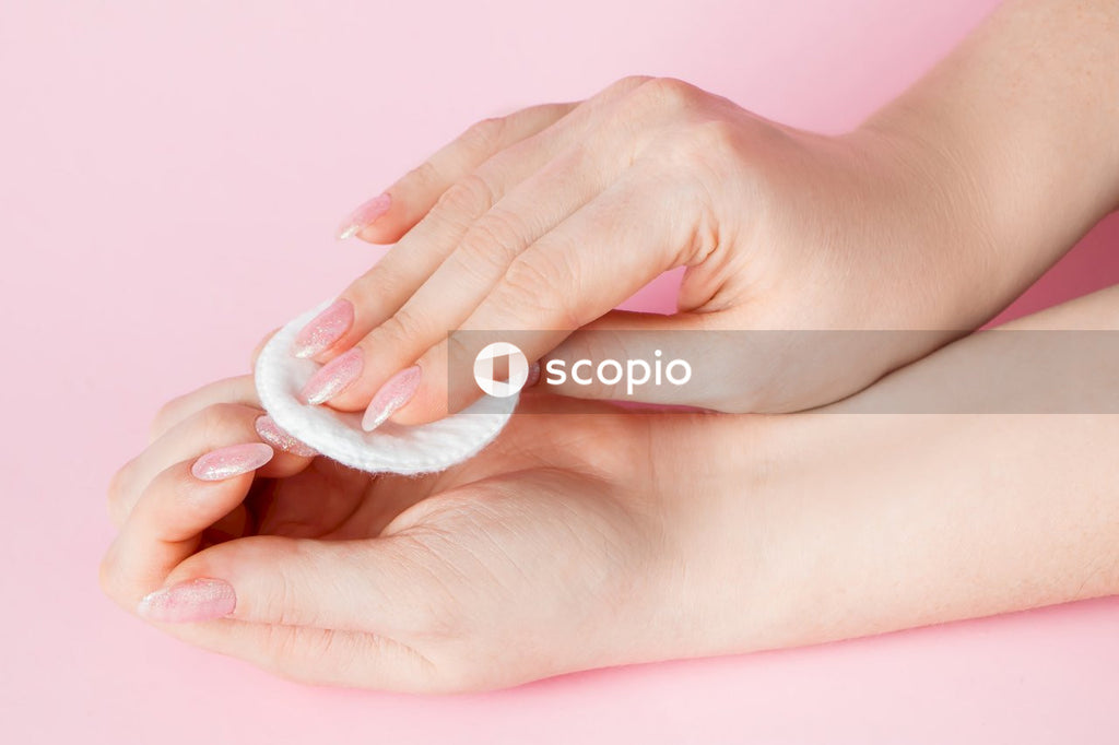 Person holding white heart shaped ornament