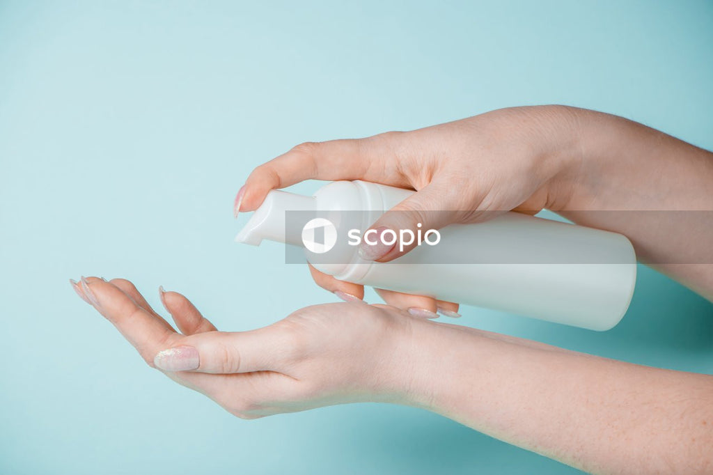 Person holding white plastic bottle