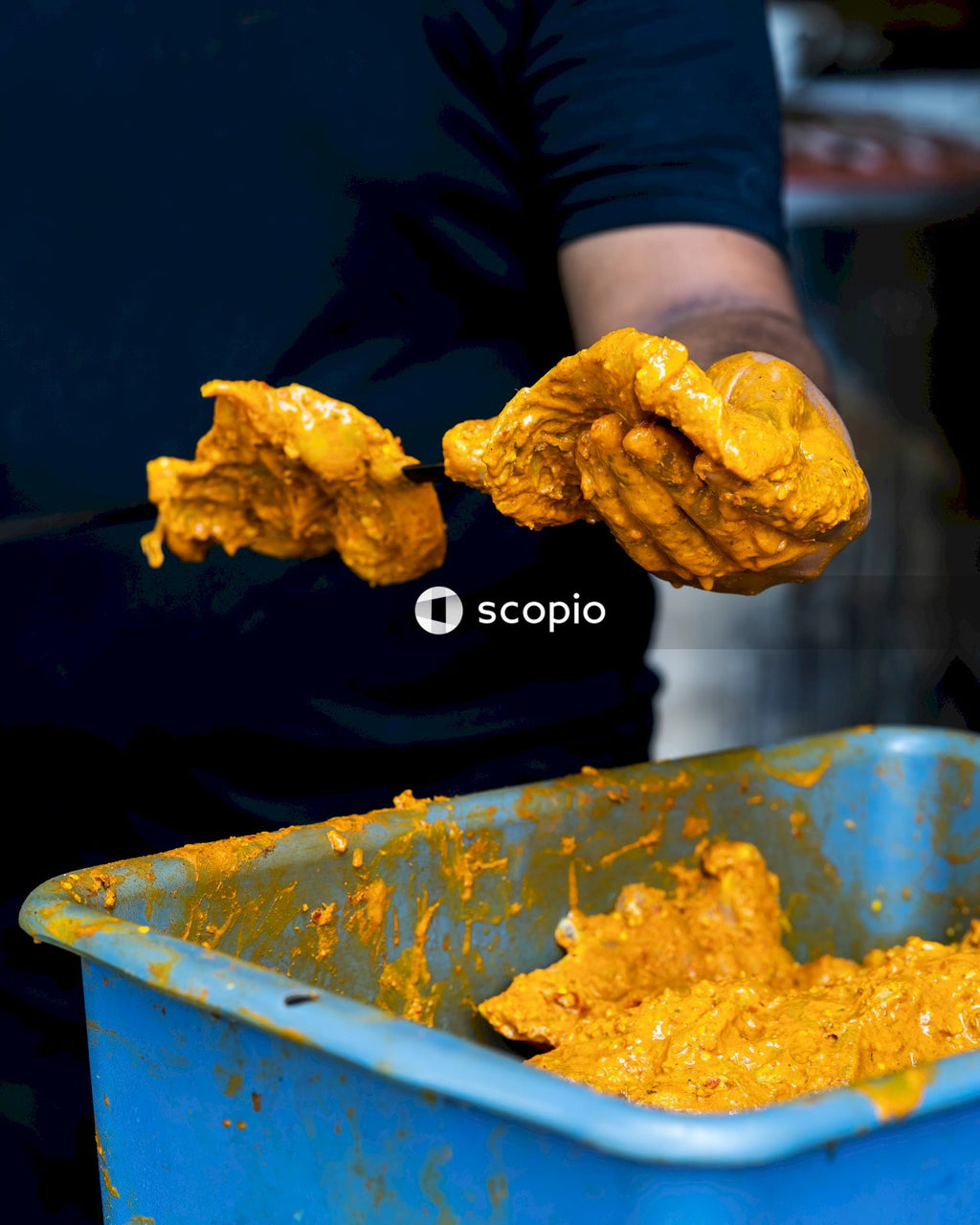 Person in black long sleeve shirt holding fried chicken