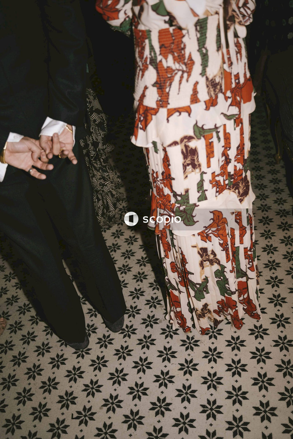 Man and a woman standing on a floral floor tiles