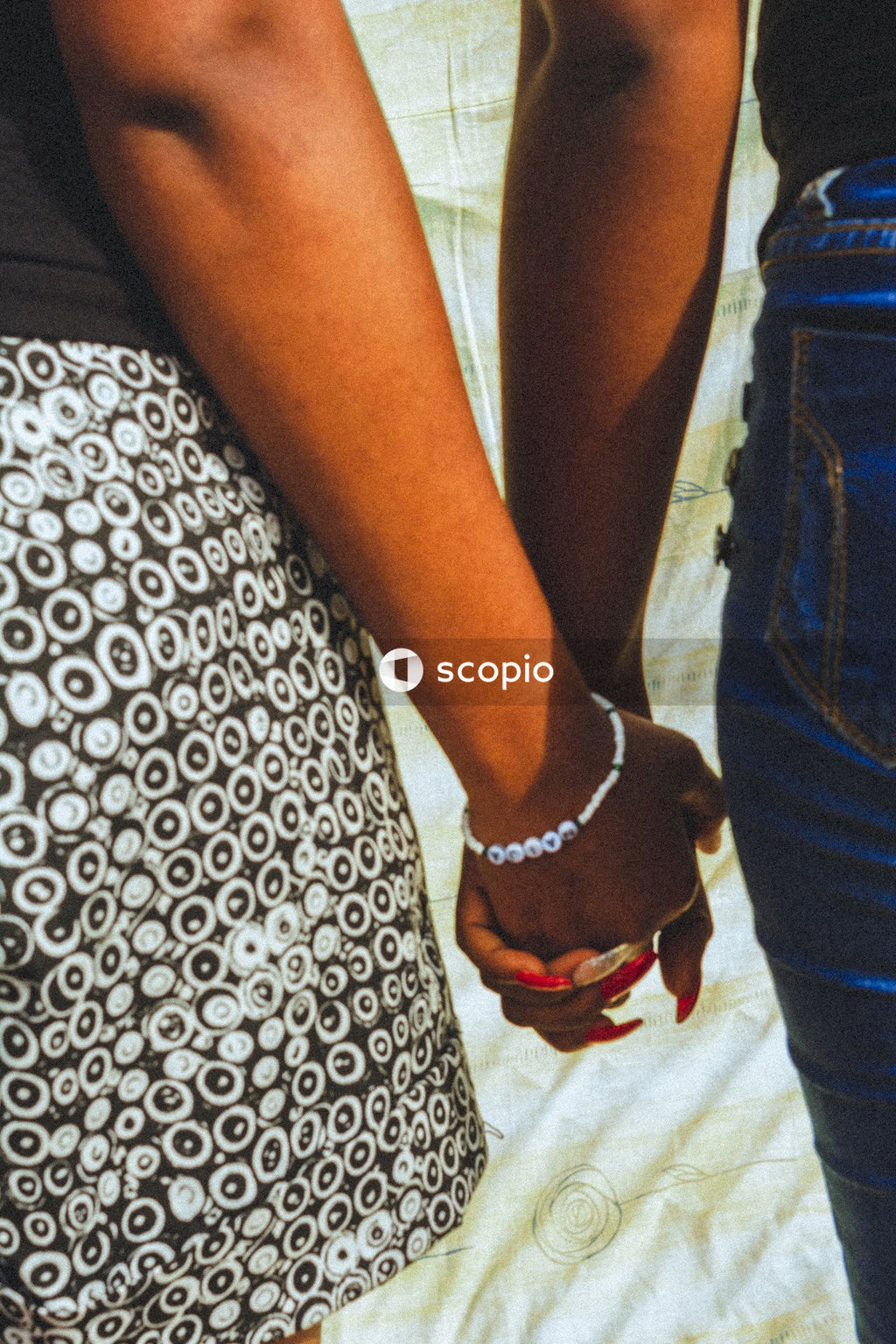 Close-up shot of two African women holding hands