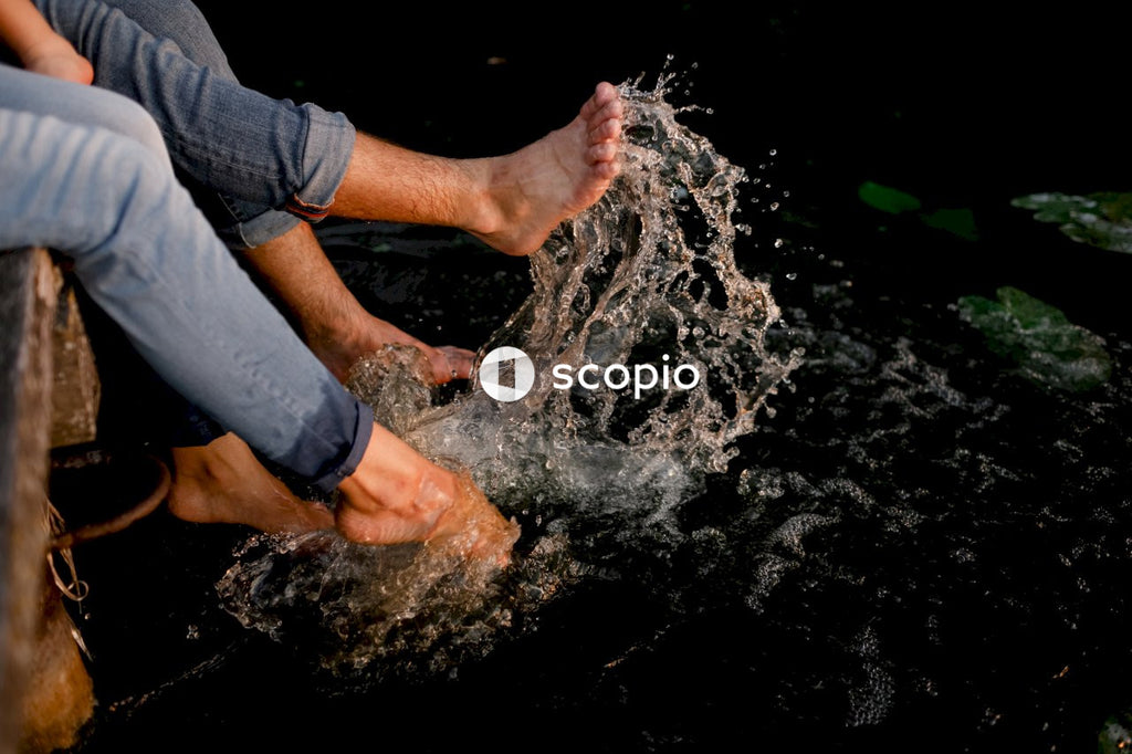Person in blue denim shorts and blue denim jeans standing on water