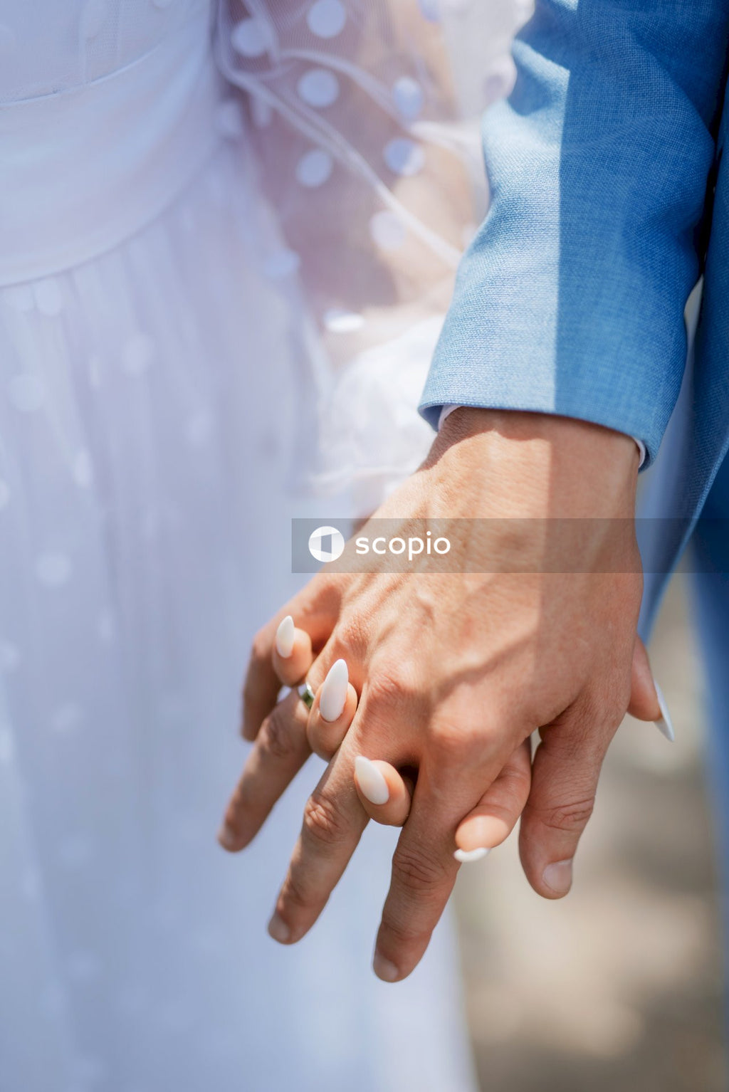 Person in blue long sleeve shirt holding persons hand