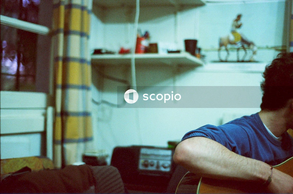 Person in blue shirt sitting on red sofa