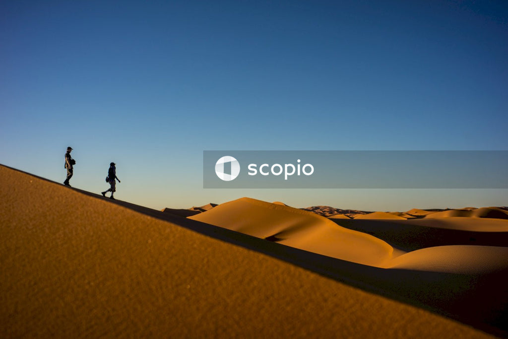 Person walking on sand dunes