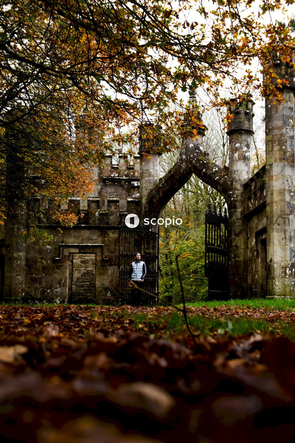 Person walking with view of Ireland's Ballysaggartmore Towers in Lismore, County Waterford's forest.