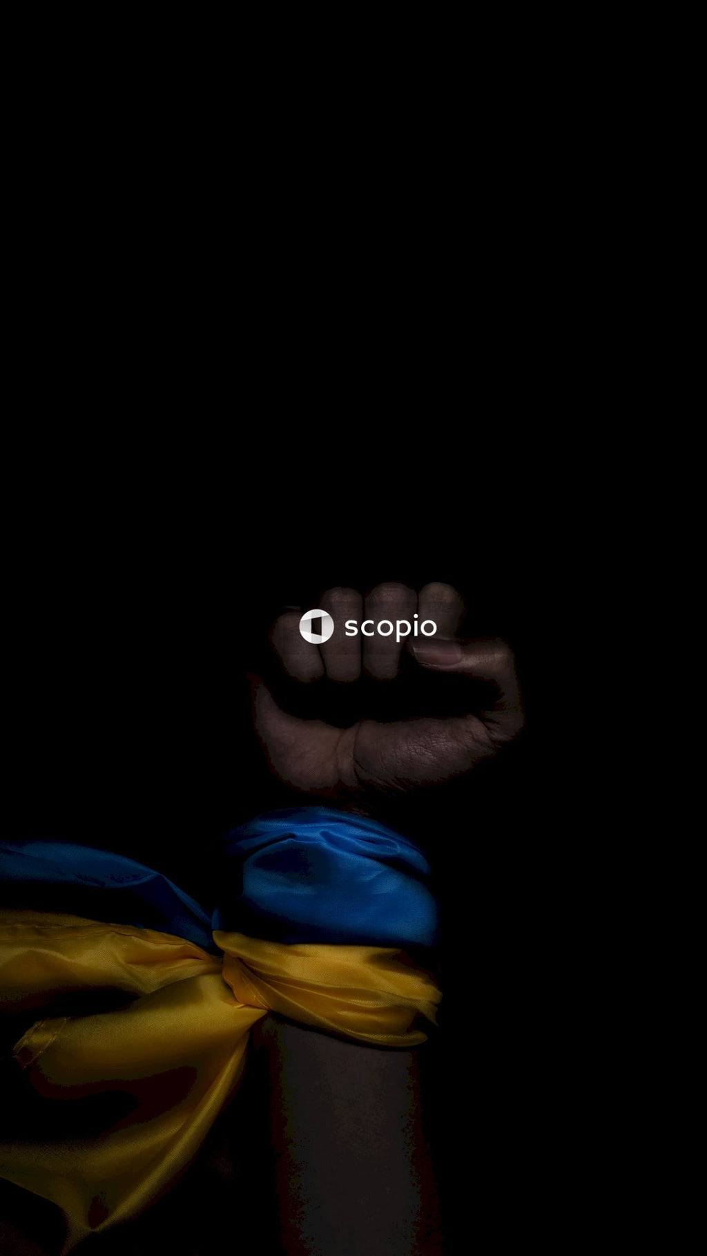 Persons hand on blue and yellow textile