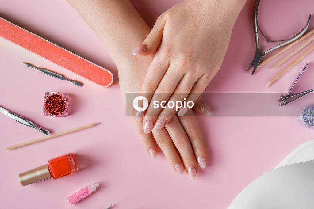 Persons hand on pink table
