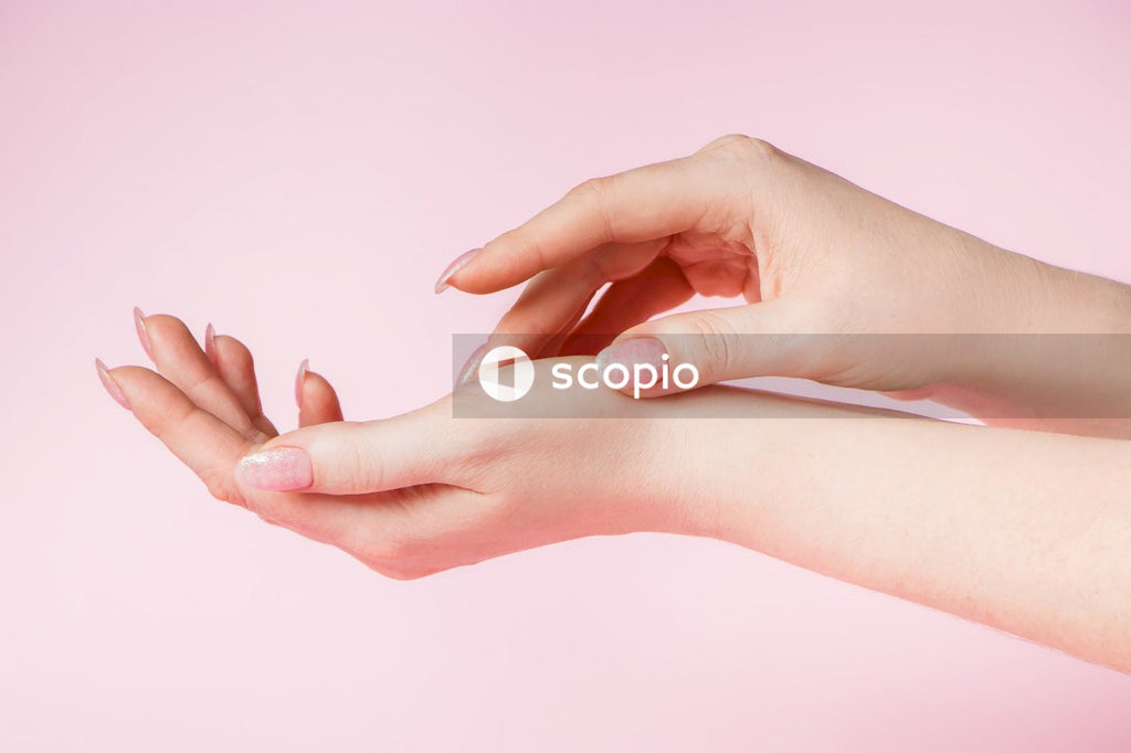 Persons hand with pink manicure