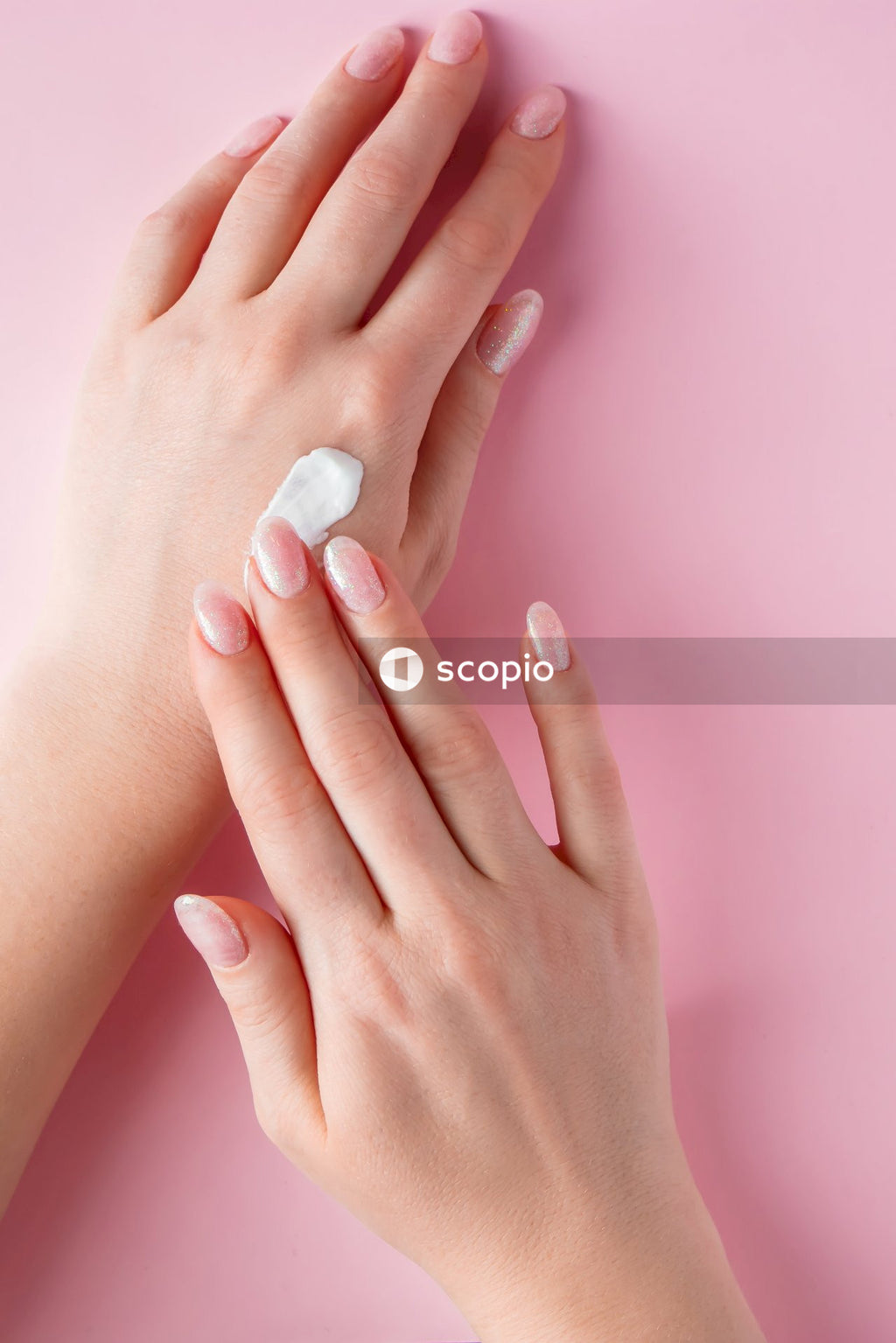 Persons hand with white manicure