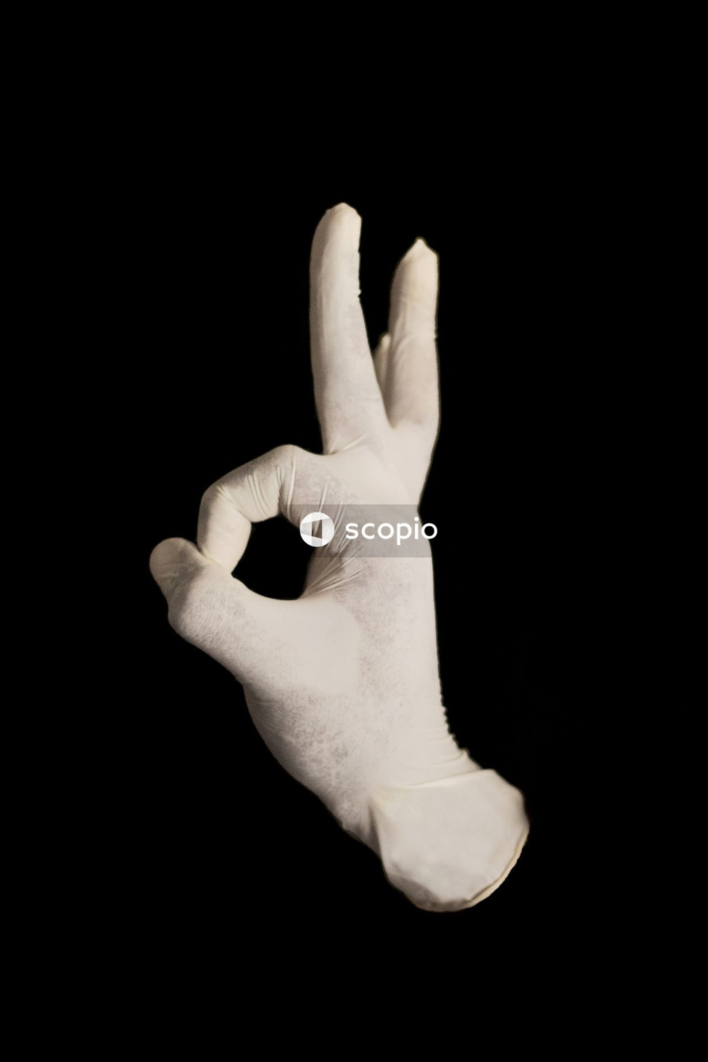 Persons left hand doing peace sign