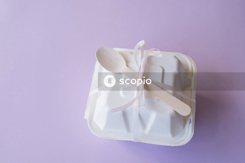 Pink ribbon on white paper