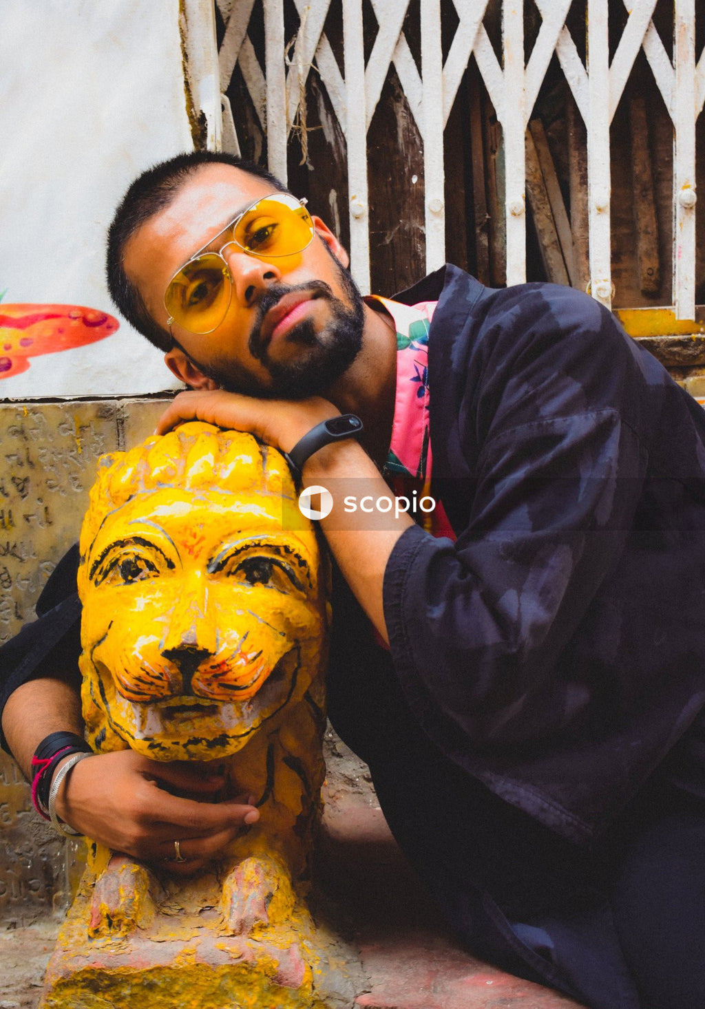 Portrait of mid adult man hugging sculpture