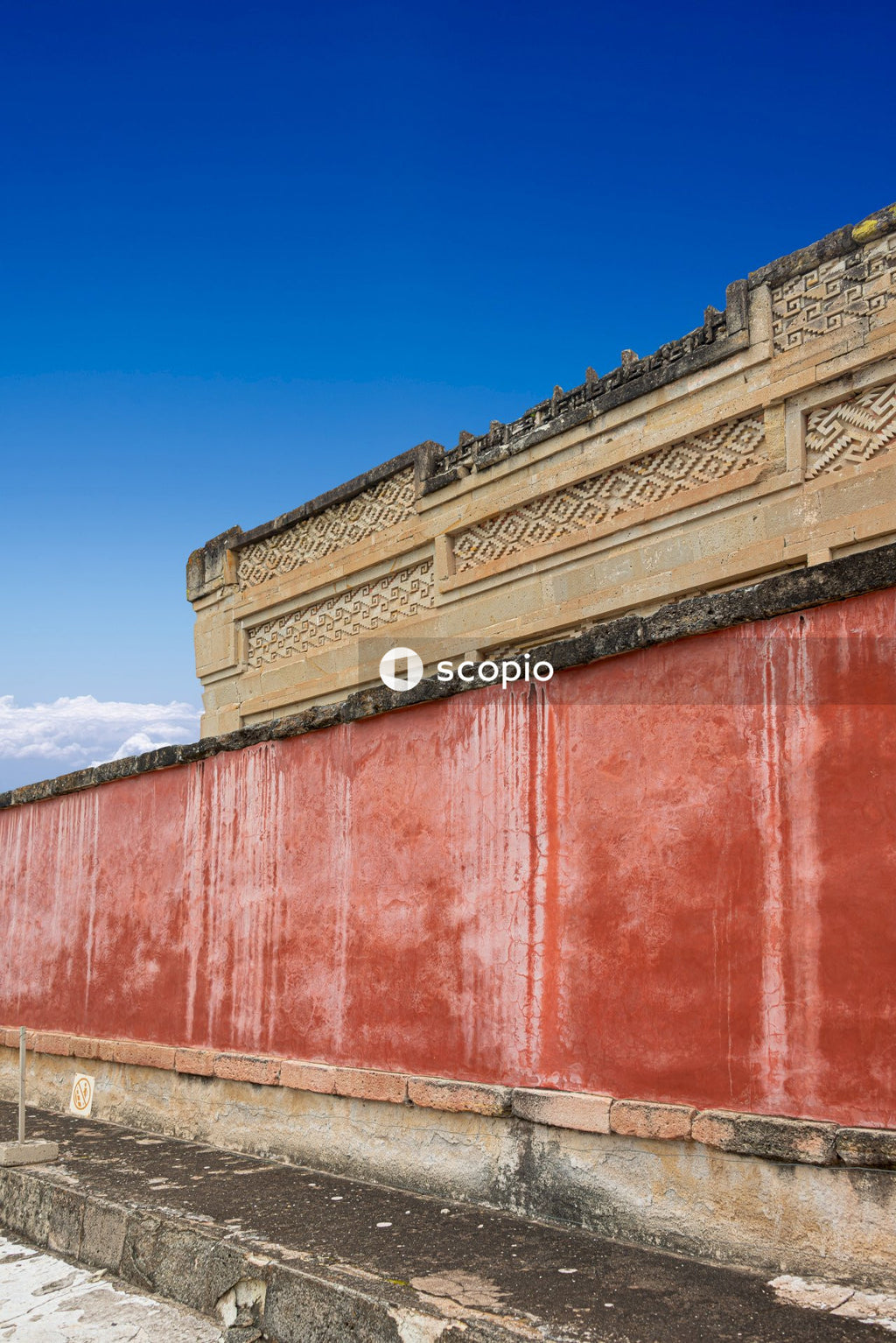 Red and beige concrete building under blue sky