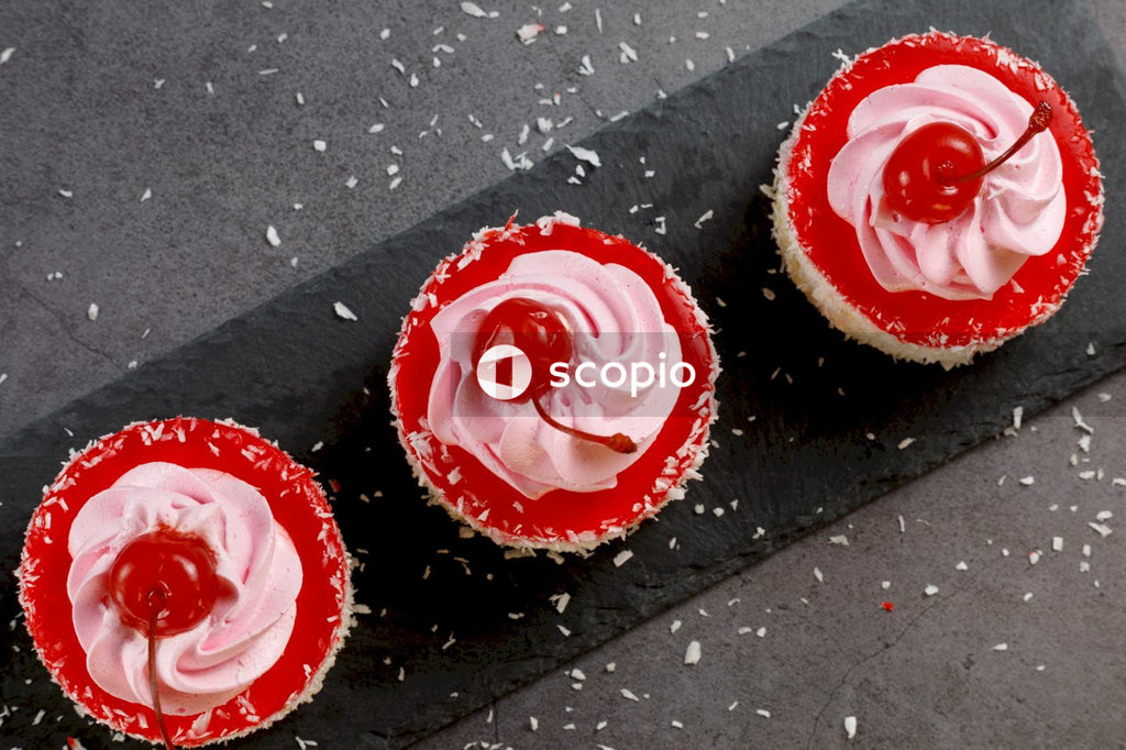 Red and black cupcakes on black surface