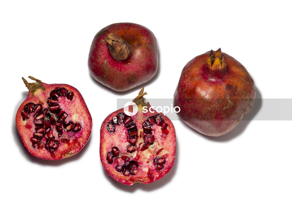 Red and brown fruit on white background