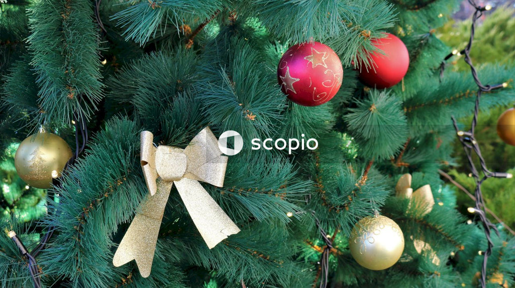 Red and gold baubles on green christmas tree