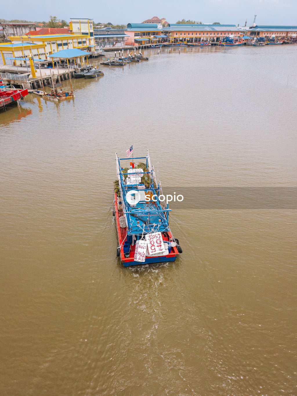 Red and green boat on body of water