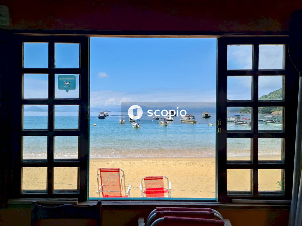 Red and white chairs and table near beach